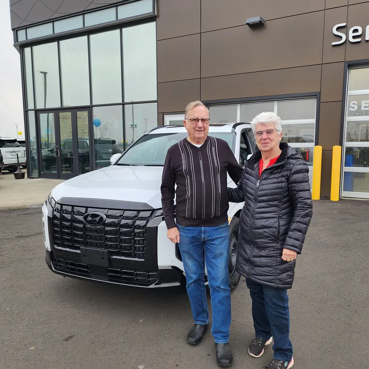 Couple with their new SUV
